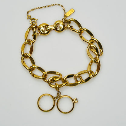 Gold-tone chain bracelet with rhinestone wedding ring charm by Monet