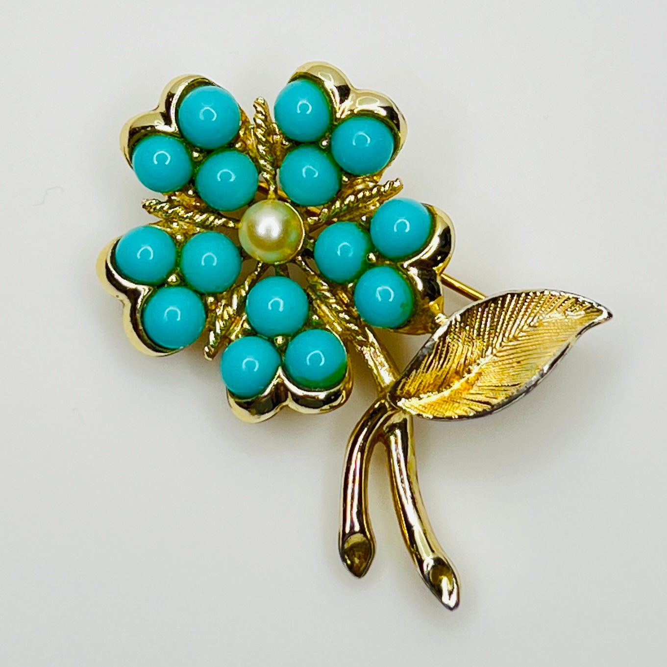 1960s floral brooch with faux turquoise cabochons and pearl center