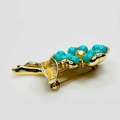 1960s floral brooch with faux turquoise cabochons and pearl center