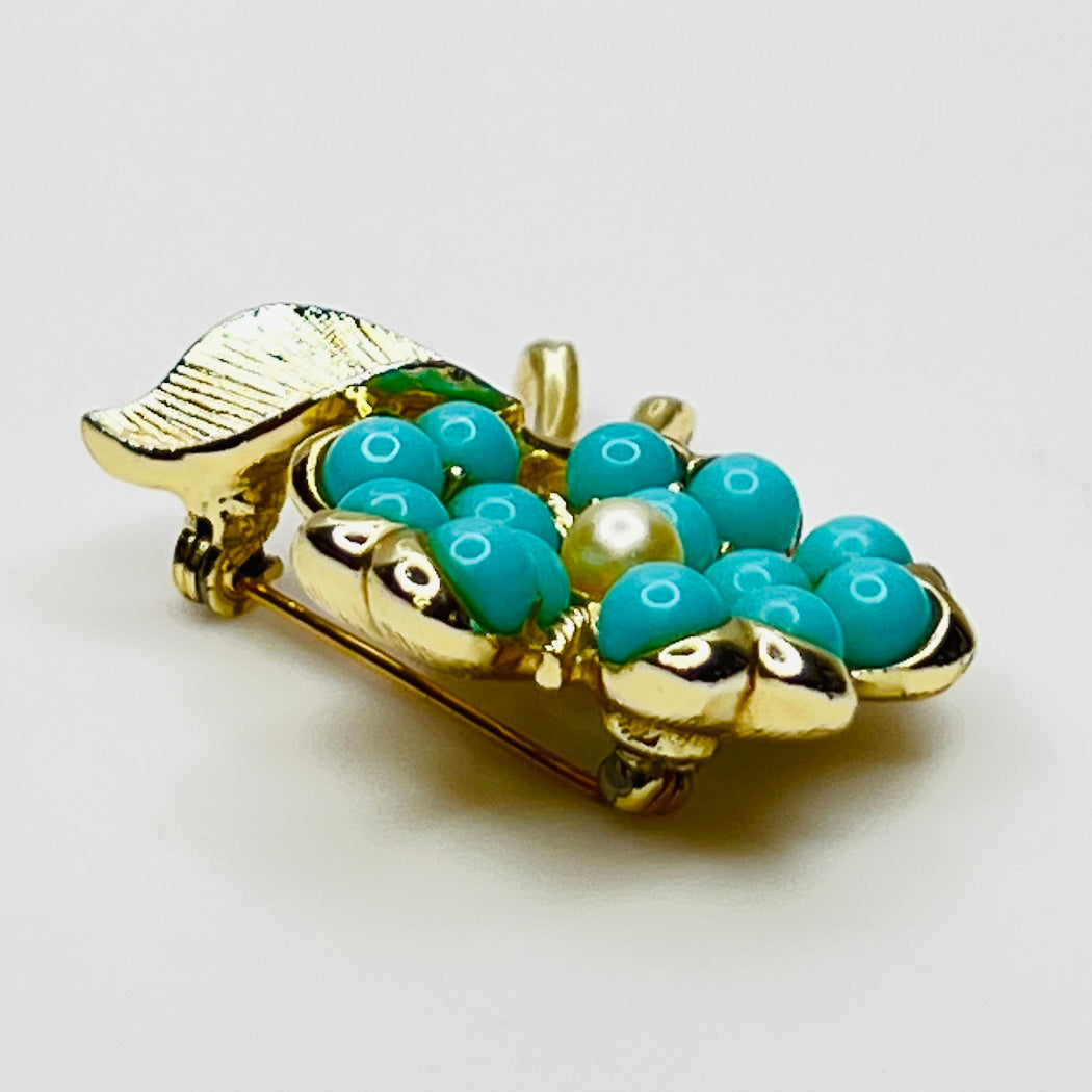 1960s floral brooch with faux turquoise cabochons and pearl center