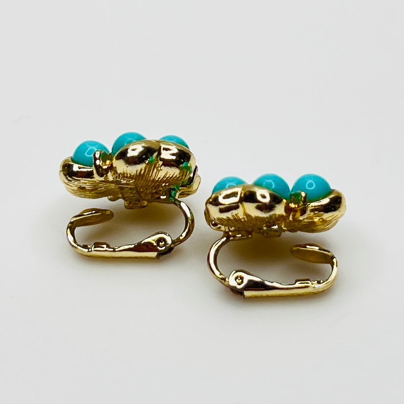 Matching clip-on earrings with gold-tone floral setting and turquoise beads