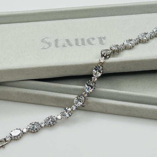Silver bracelet with clear stones on a Stauer branded box