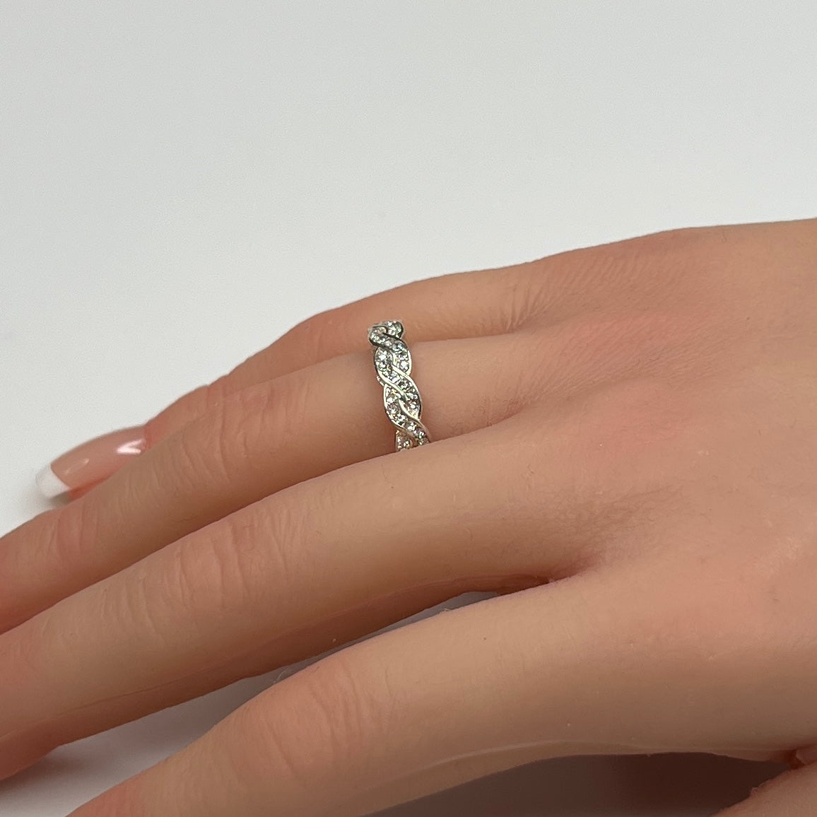 Braided crystal band ring shown on hand, size 7.5