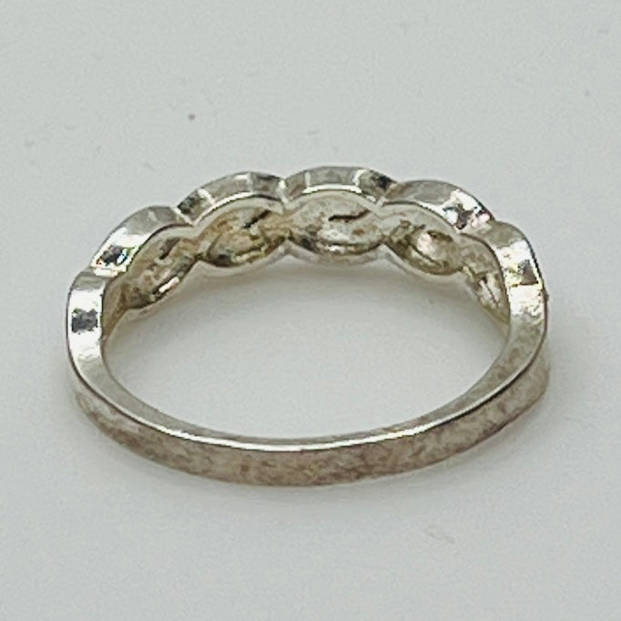 Rear view of sterling silver eternity ring showing 925 stamp and braided form