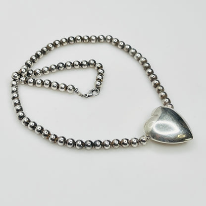 Side view Flat lay of vintage sterling heart necklace with lobster clasp