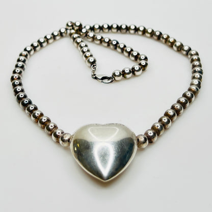 Side view Flat lay of vintage sterling heart necklace with lobster clasp