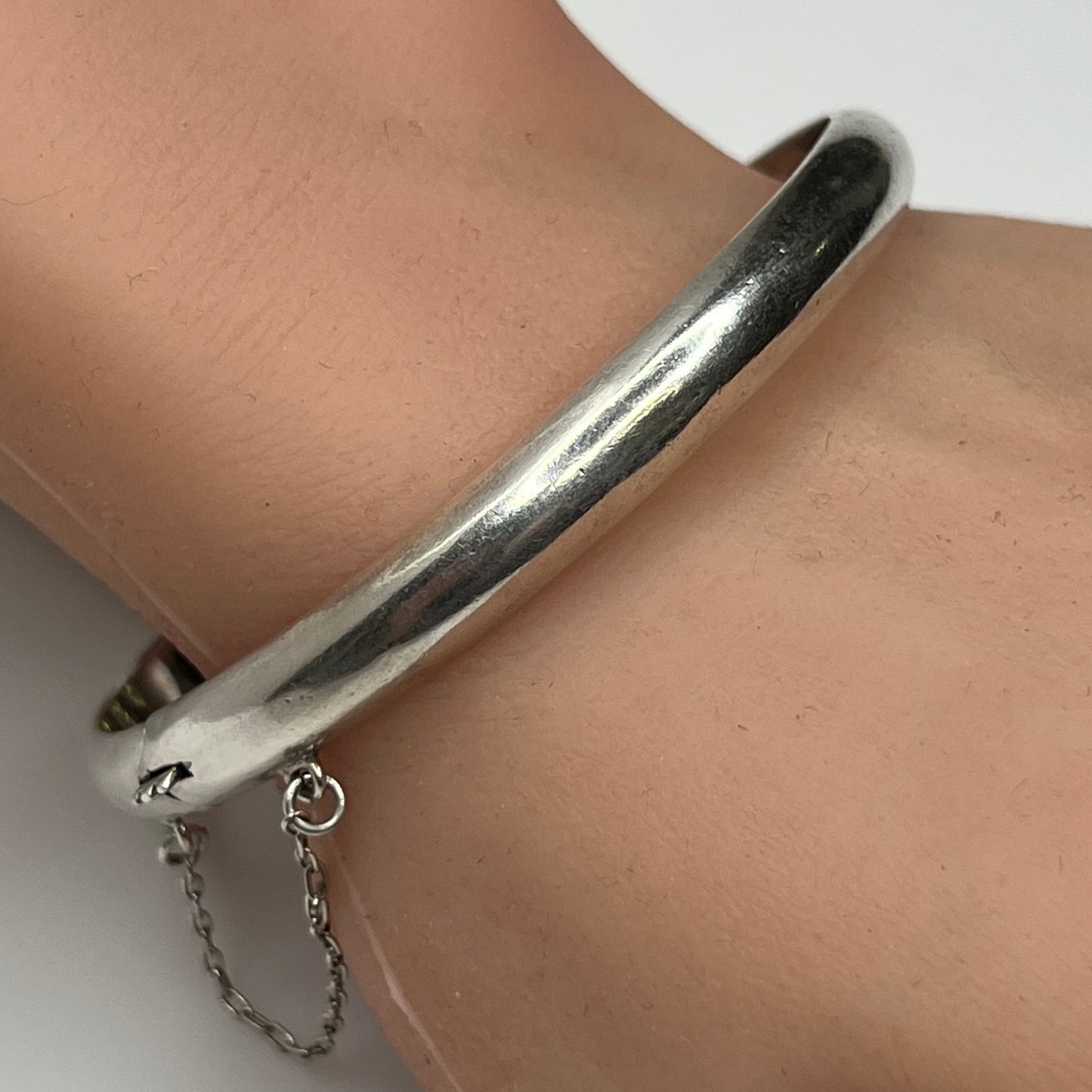 Sterling silver vintage bangle bracelet on wrist – smooth polished finish