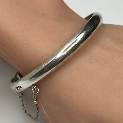 Sterling silver vintage bangle bracelet on wrist – smooth polished finish
