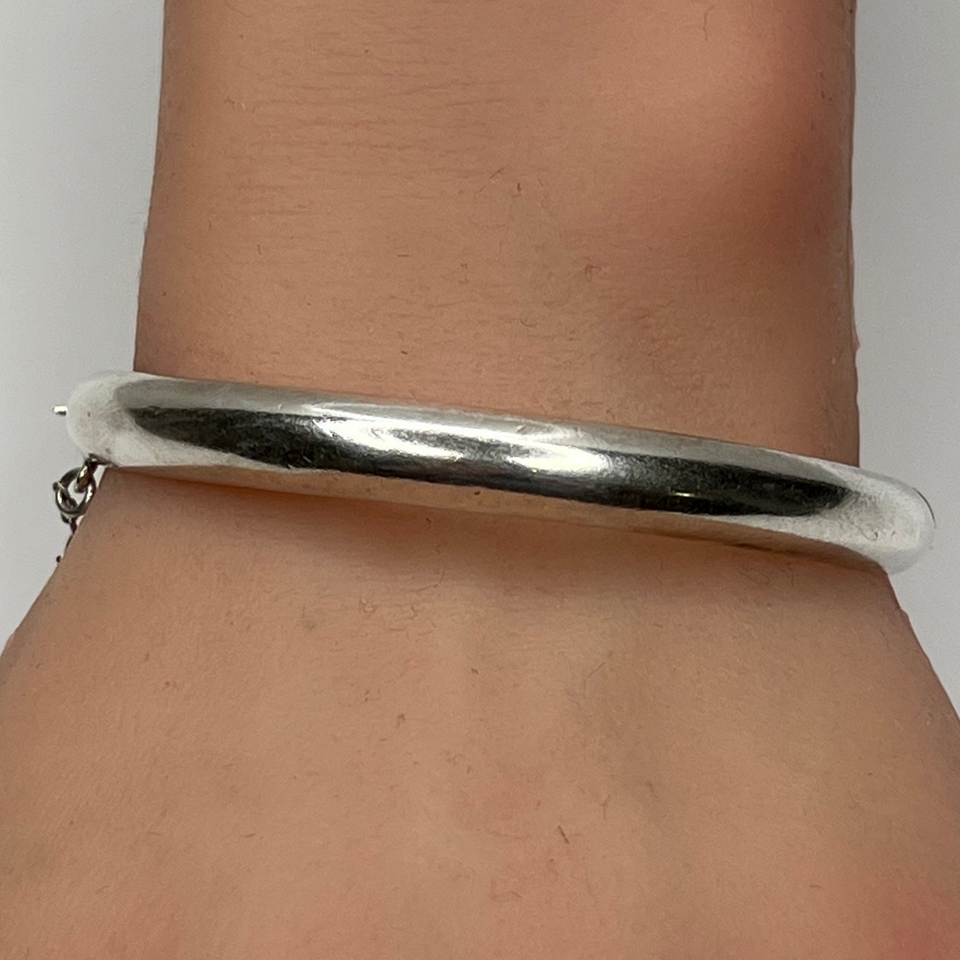 Sterling silver vintage bangle bracelet on wrist – smooth polished finish
