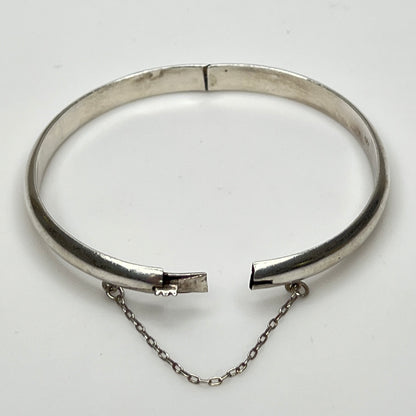 Full view of 1980s bangle with safety chain, laying flat