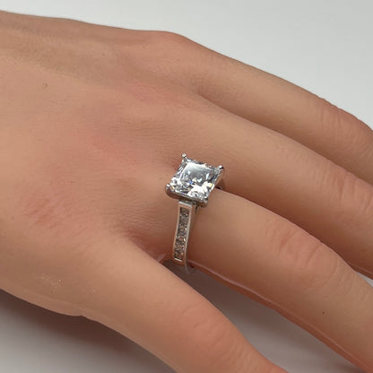 Sterling silver bridal set on model hand with princess-cut solitaire