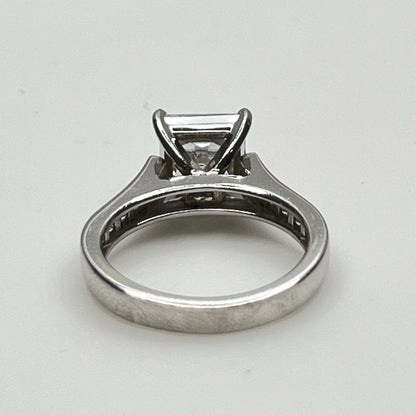 CZ ring with a square-cut gemstone on a light gray background