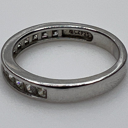 Silver ring with embedded cubic Zirconia on a light gray background