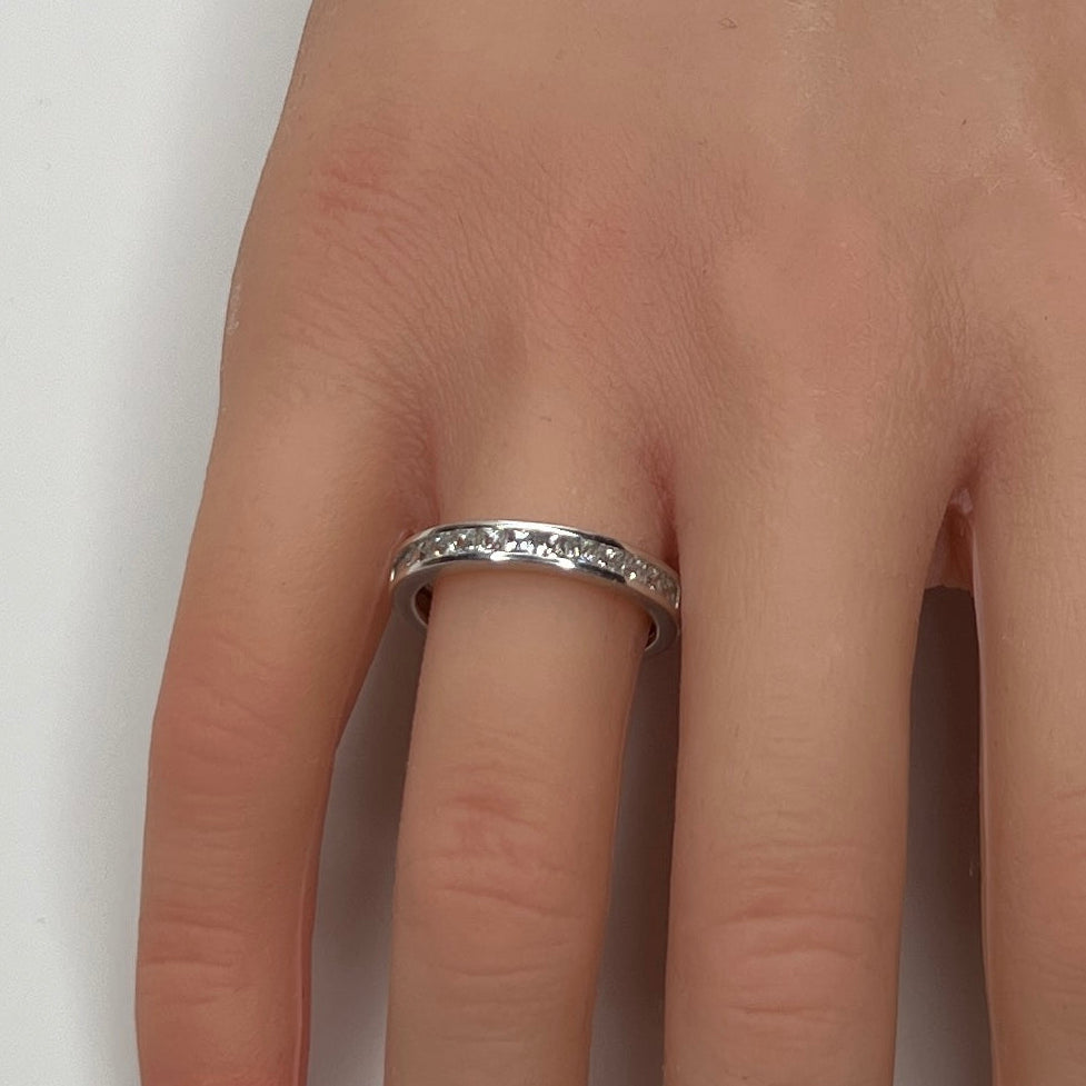 Sterling silver bridal set on model hand with princess-cut solitaire