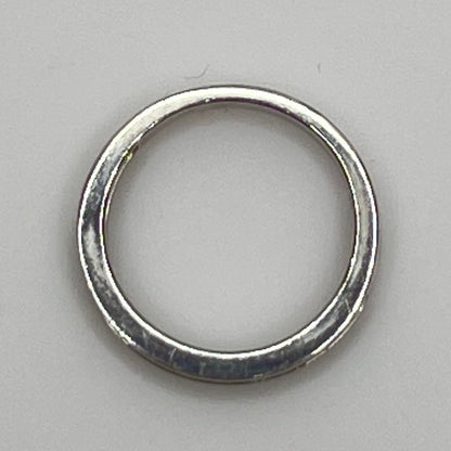 Silver ring with embedded cubic Zirconia on a light gray background