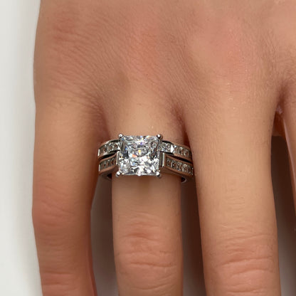 Sterling silver bridal set on model hand with princess-cut solitaire