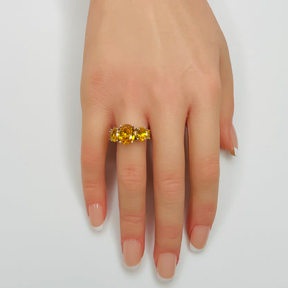 Sterling silver citrine ring worn on a hand, showing five faceted oval stones