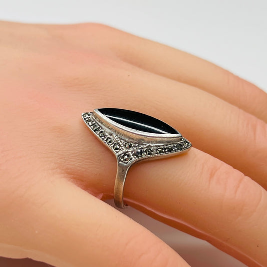 Sterling silver black onyx and marcasite ring worn on hand, marquise shape