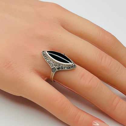 Sterling silver black onyx and marcasite ring worn on hand, marquise shape