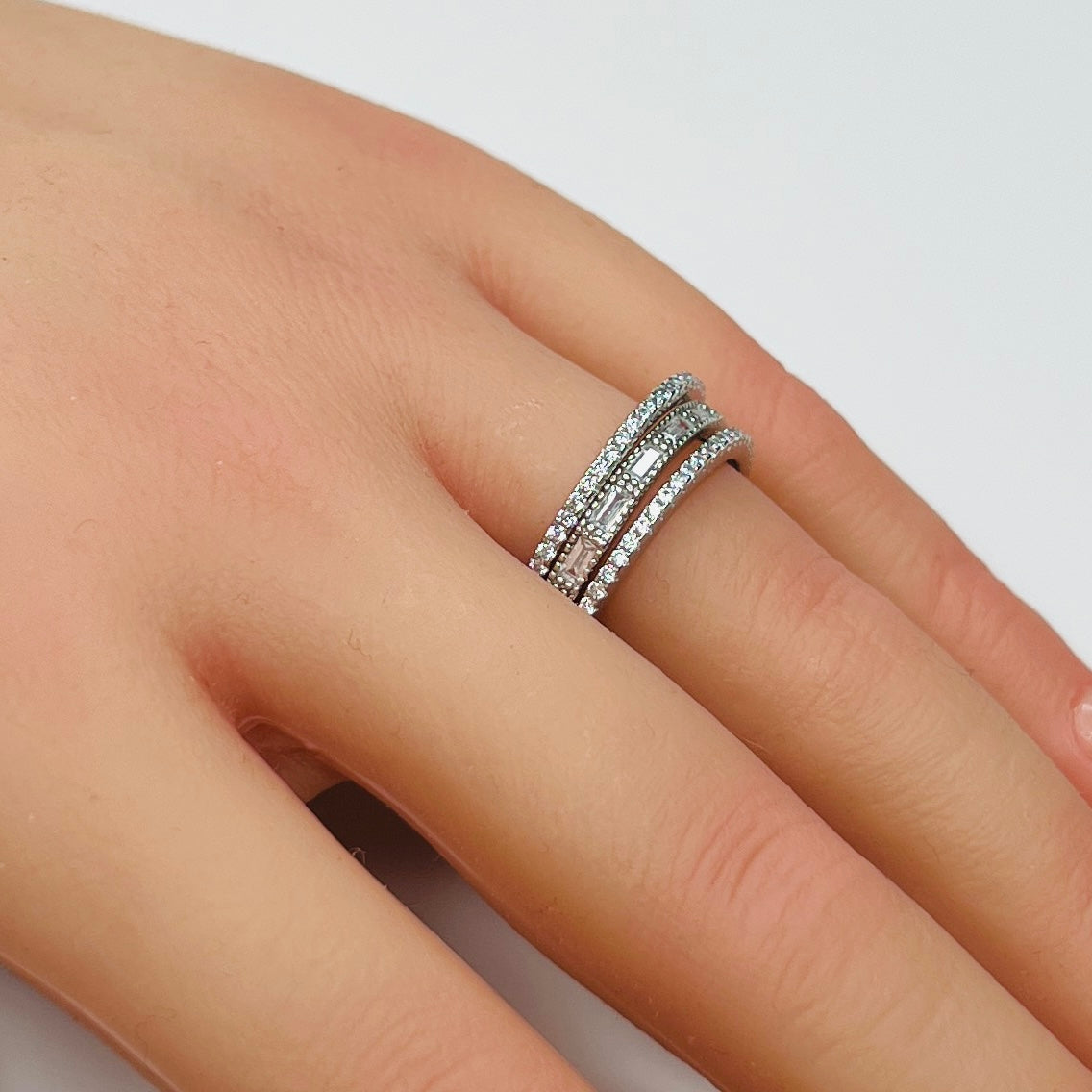 Sterling silver crystal ring trio stacked on hand