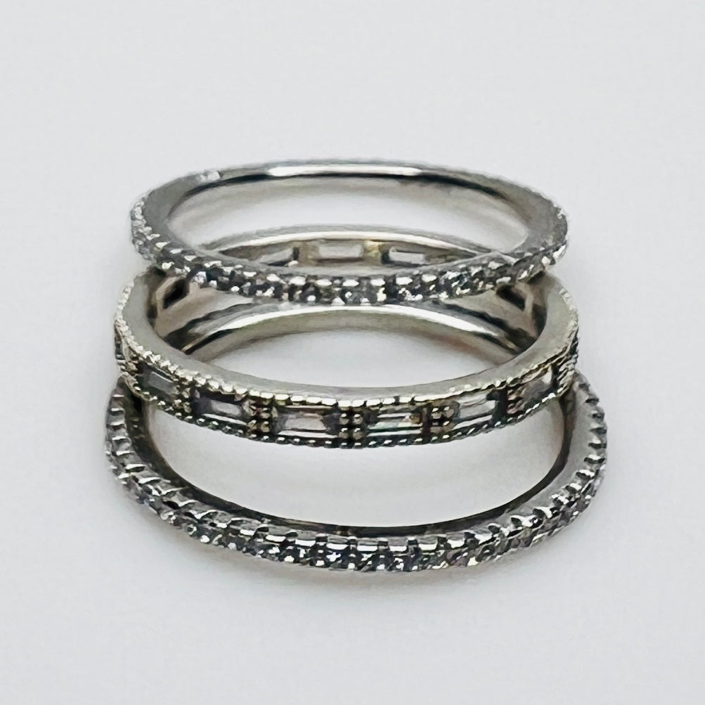 Close-up of 3 crystal eternity bands with baguette and pavé styles