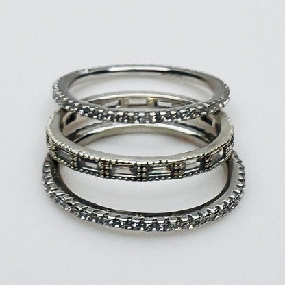 Close-up of 3 crystal eternity bands with baguette and pavé styles