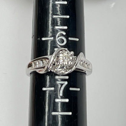 Close-up of diamond bypass ring with round and baguette stones