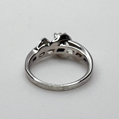 Close-up of diamond bypass ring with round and baguette stones