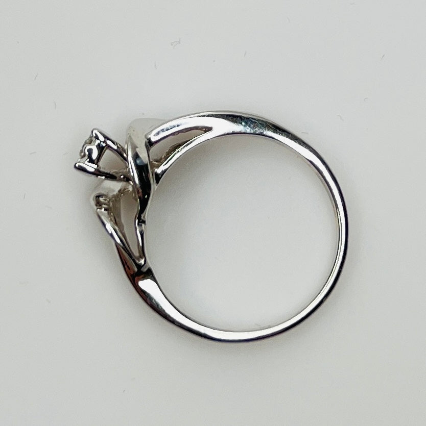 Close-up of diamond bypass ring with round and baguette stones