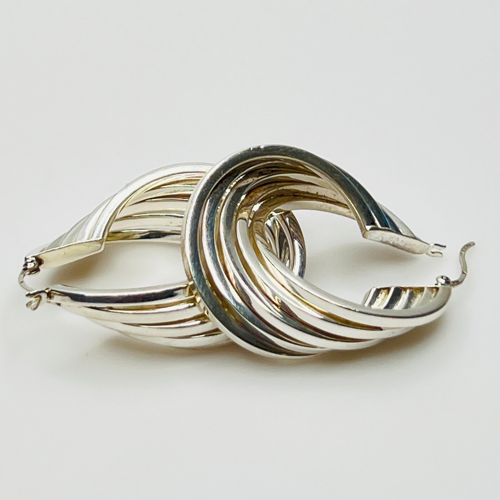 Sculptural ridged silver hoops with fluid layered design