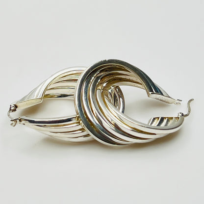 Sculptural ridged silver hoops with fluid layered design