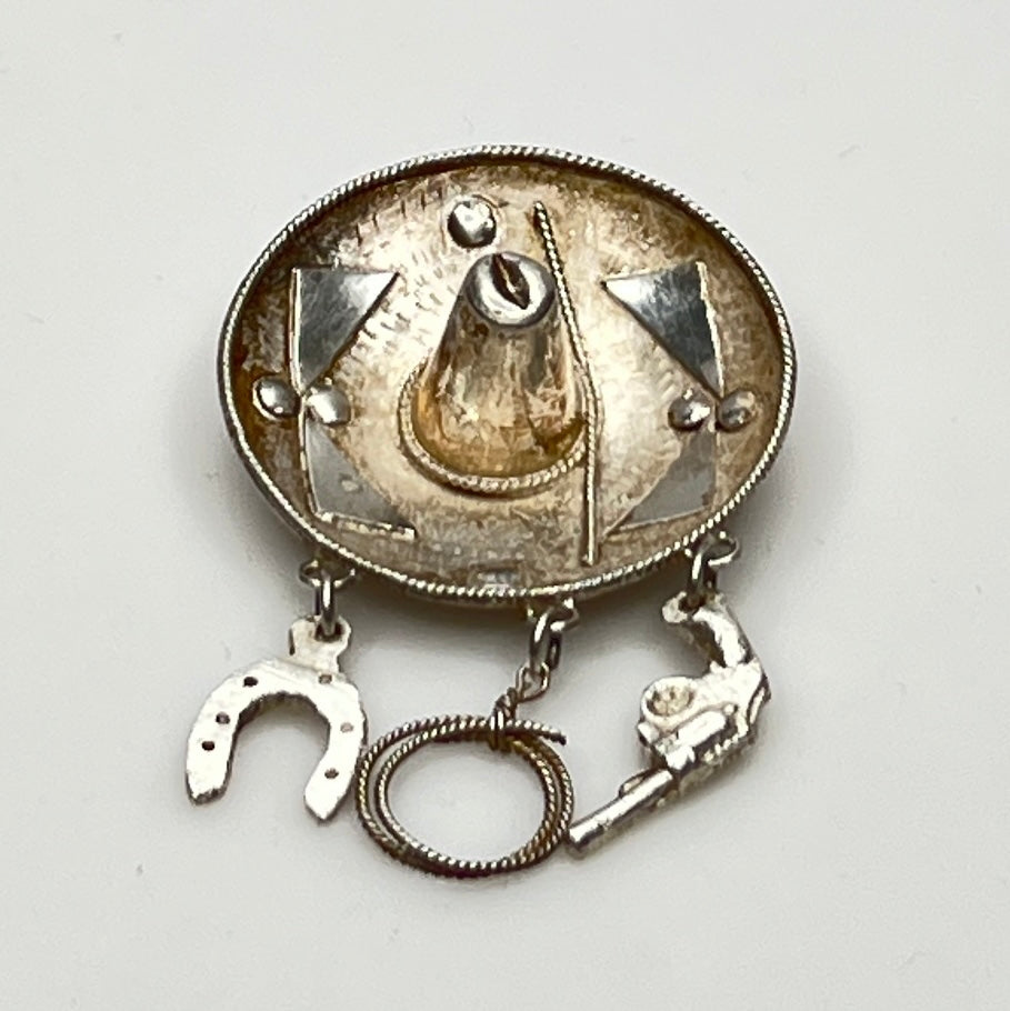Vintage sombrero hat brooch in silver showing 3D brim and charm depth – angled view