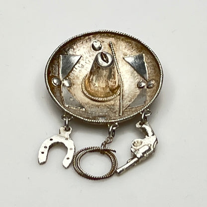 Vintage sombrero hat brooch in silver showing 3D brim and charm depth – angled view