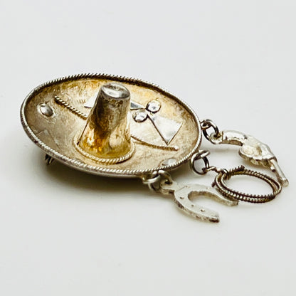 Vintage sombrero hat brooch in silver showing 3D brim and charm depth – angled view