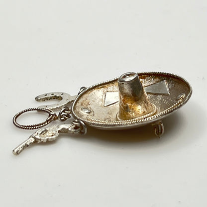 Vintage sombrero hat brooch in silver showing 3D brim and charm depth – angled view