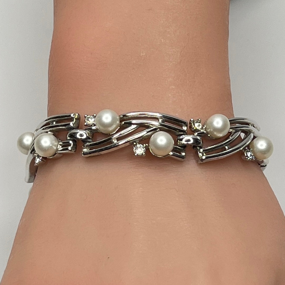 Trifari silver-tone bracelet with faux pearls and rhinestones worn on wrist