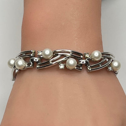Trifari silver-tone bracelet with faux pearls and rhinestones worn on wrist