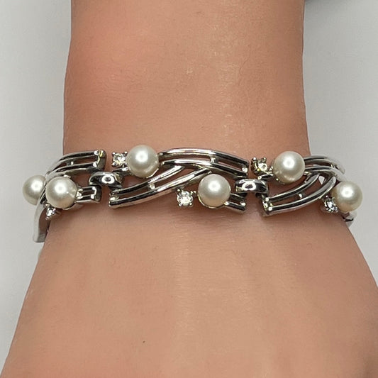 Trifari silver-tone bracelet with faux pearls and rhinestones worn on wrist