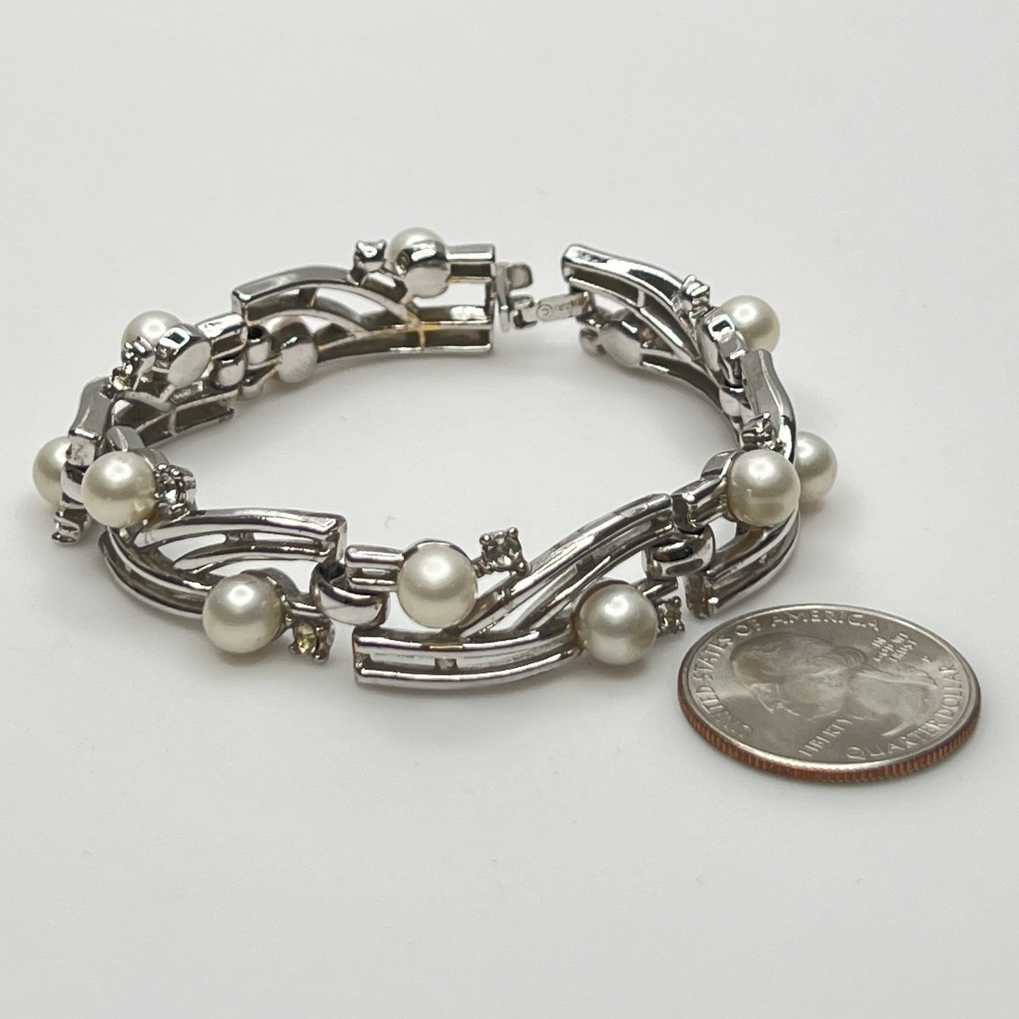 Trifari vintage bracelet with wavy silver panels and pearls laid flat