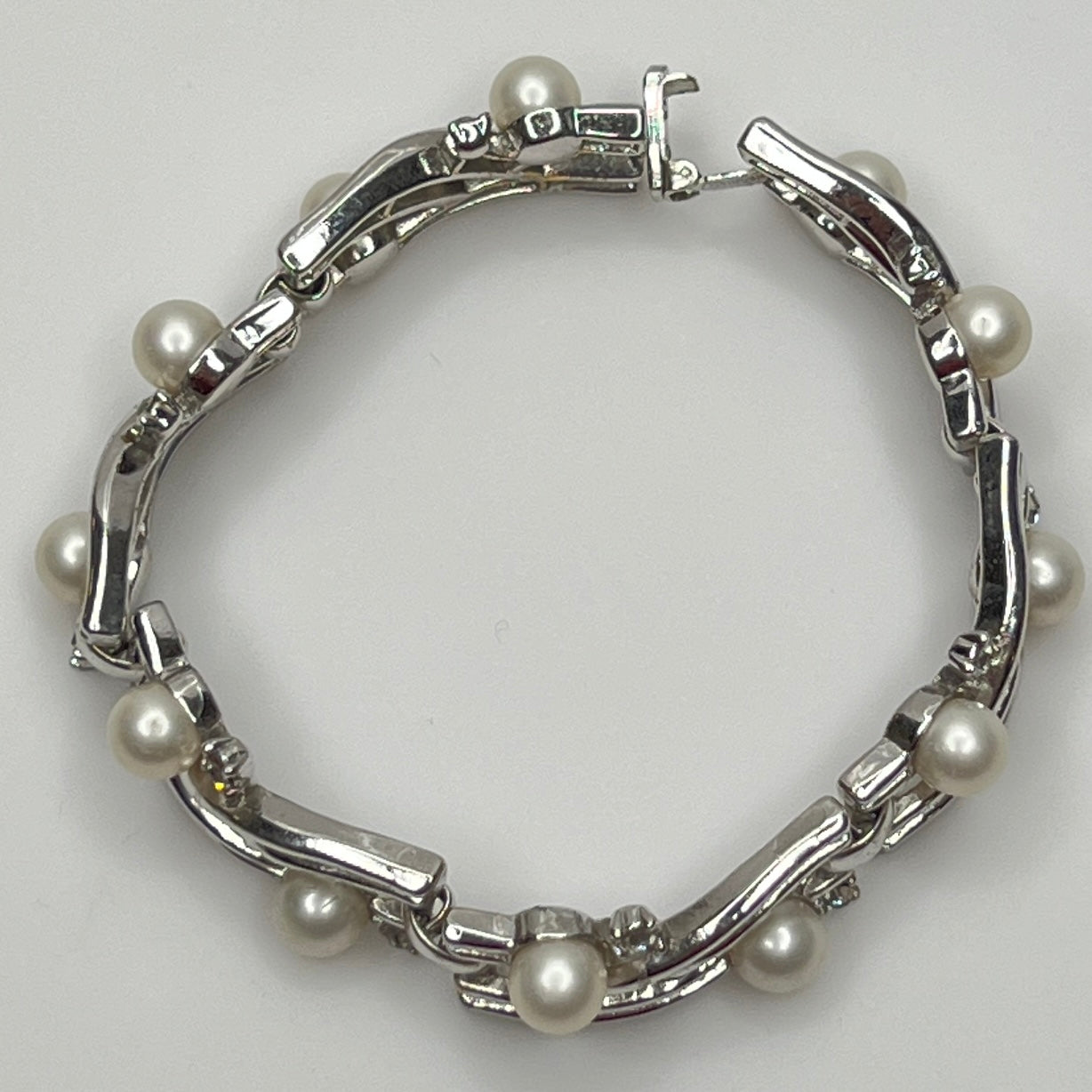 Trifari vintage bracelet with wavy silver panels and pearls laid flat