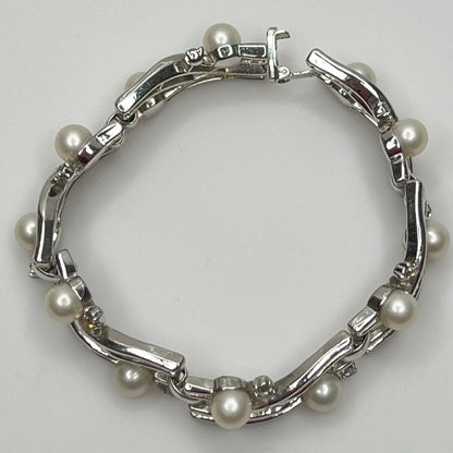 Trifari vintage bracelet with wavy silver panels and pearls laid flat