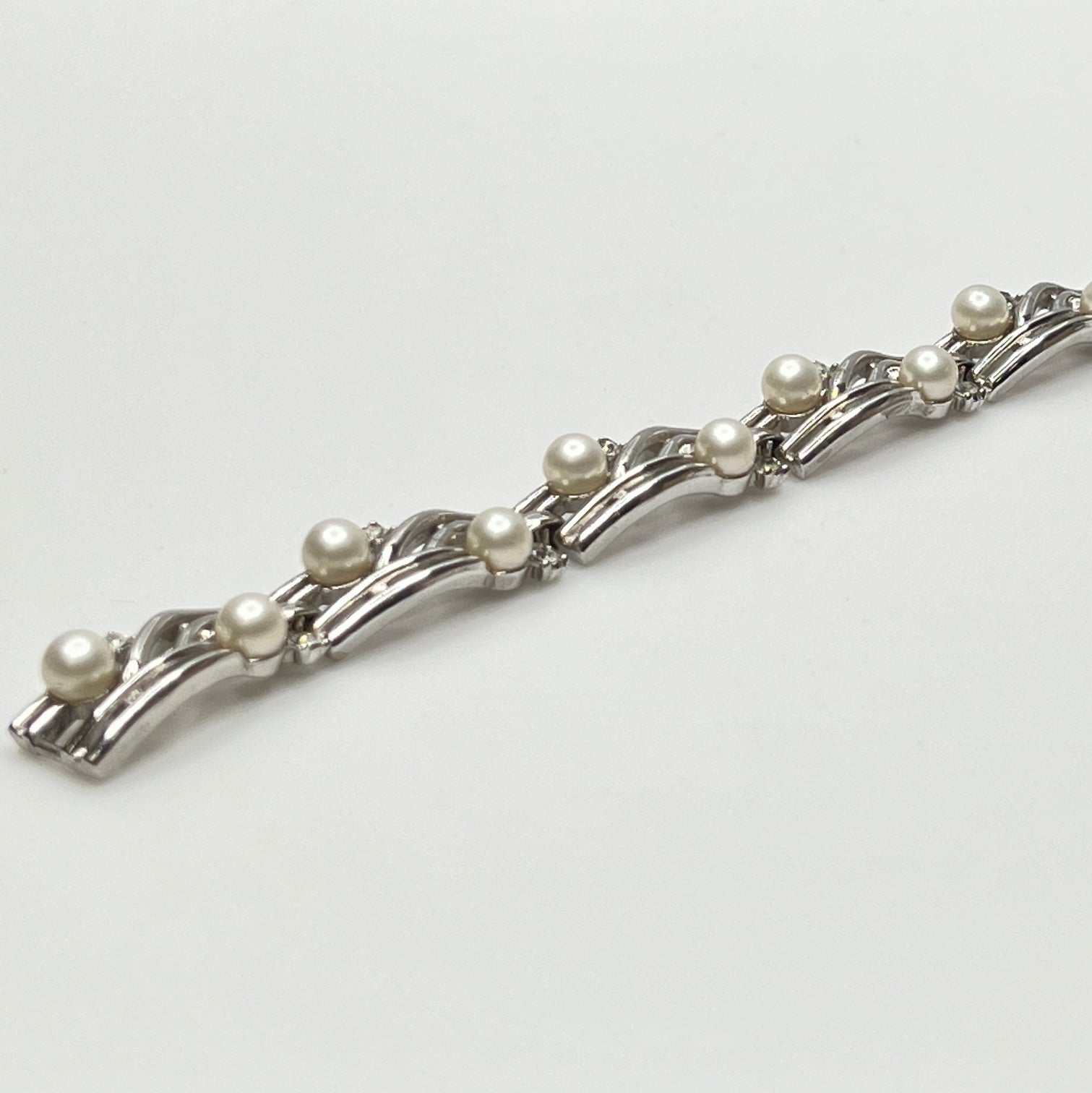 Trifari vintage bracelet with wavy silver panels and pearls laid flat