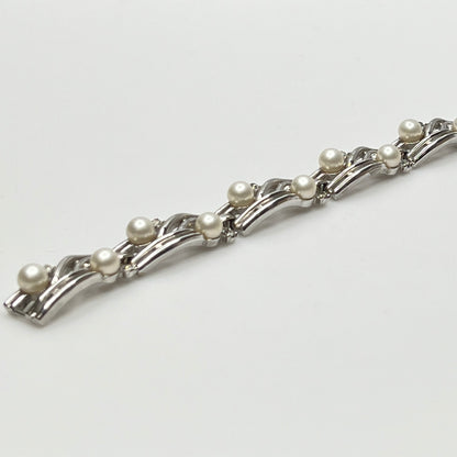 Trifari vintage bracelet with wavy silver panels and pearls laid flat