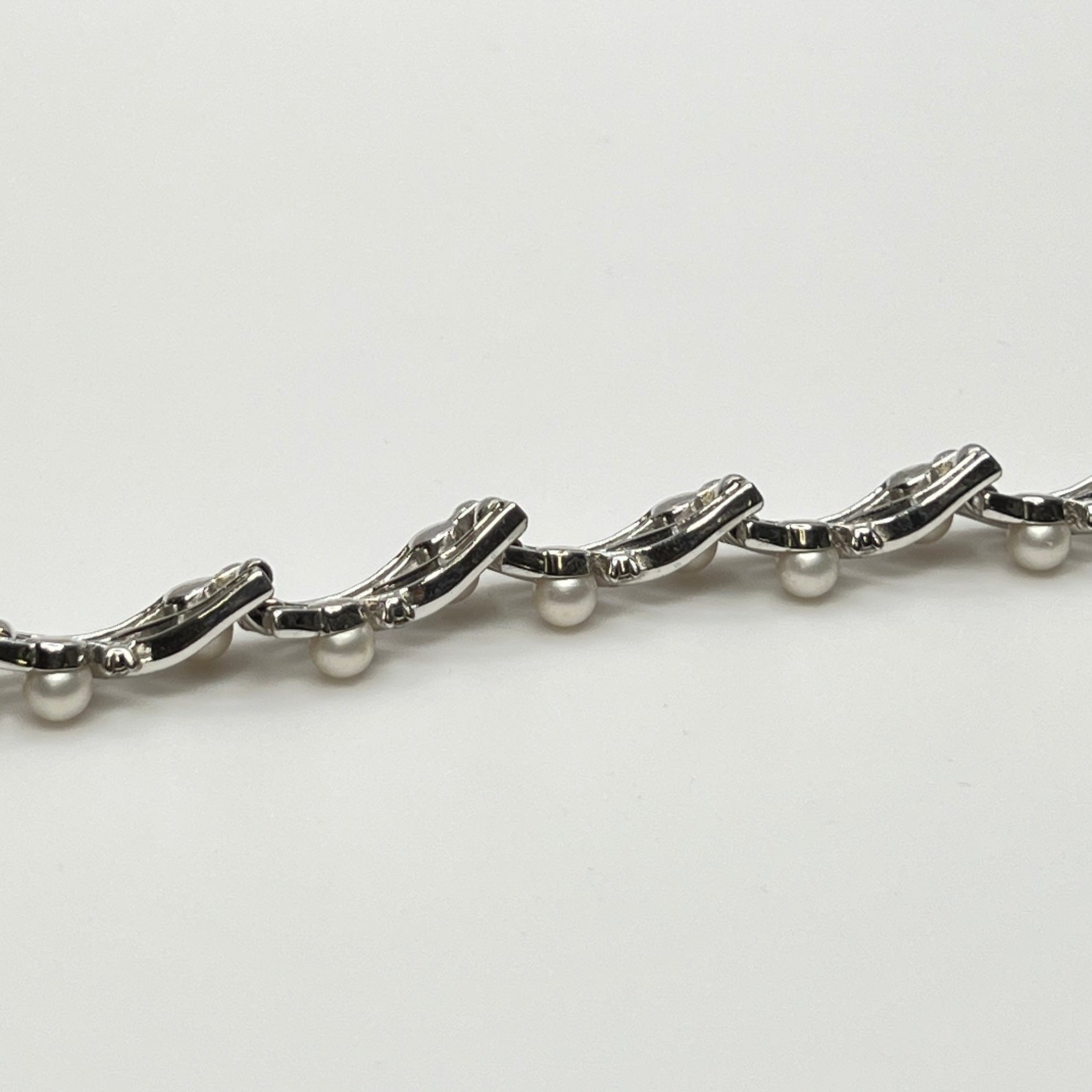 Trifari vintage bracelet with wavy silver panels and pearls laid flat