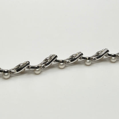 Trifari vintage bracelet with wavy silver panels and pearls laid flat