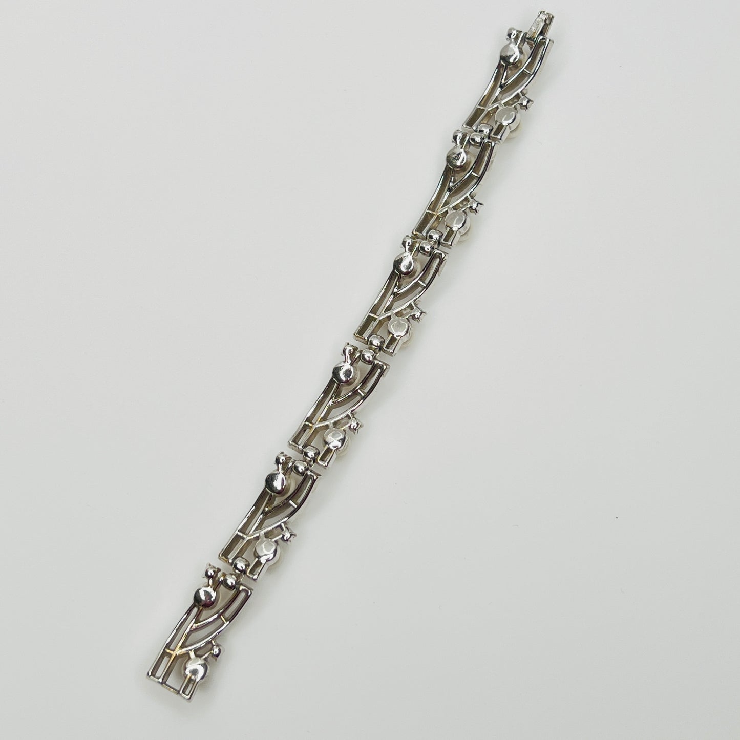Trifari vintage bracelet with wavy silver panels and pearls laid flat