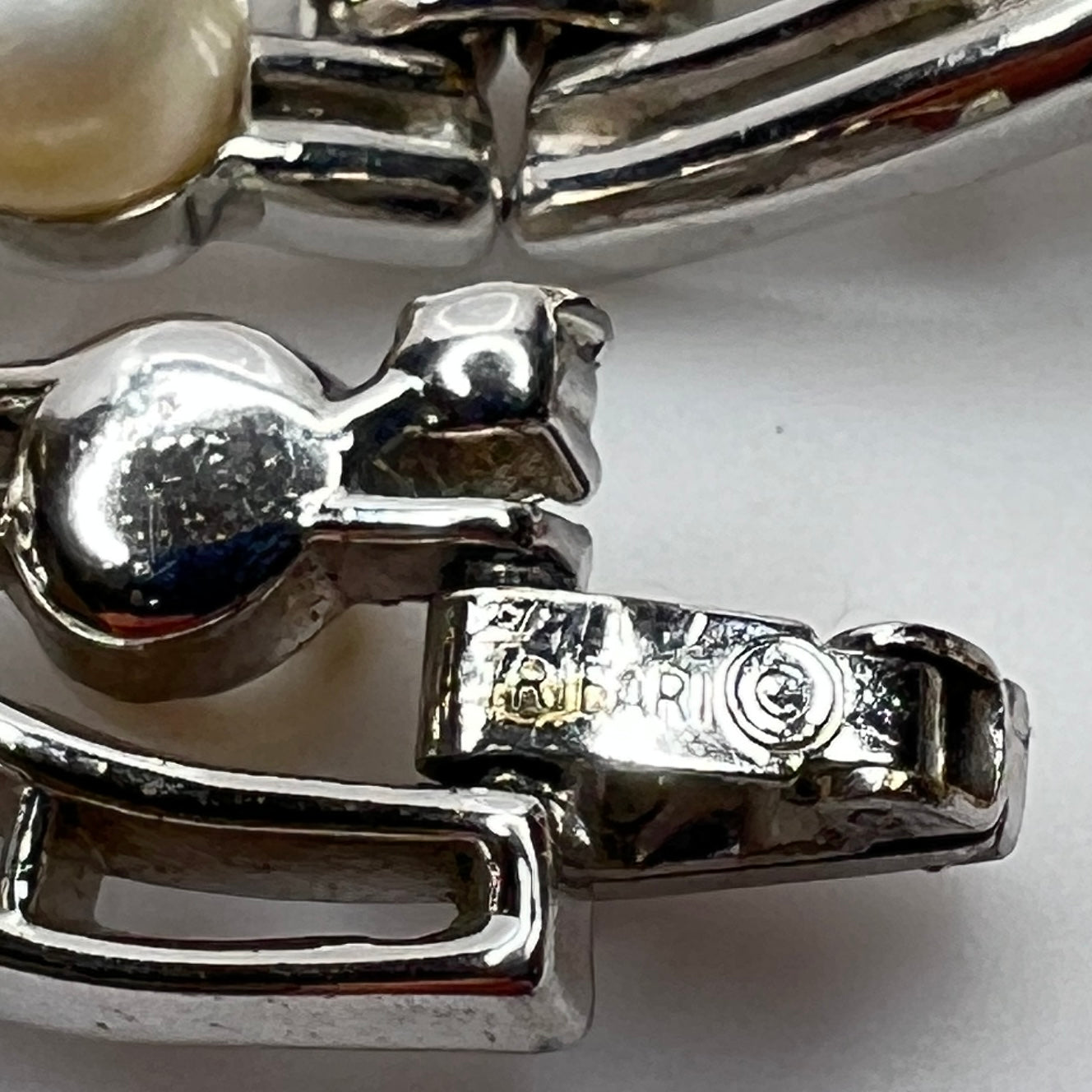 Trifari vintage bracelet with wavy silver panels and pearls laid flat