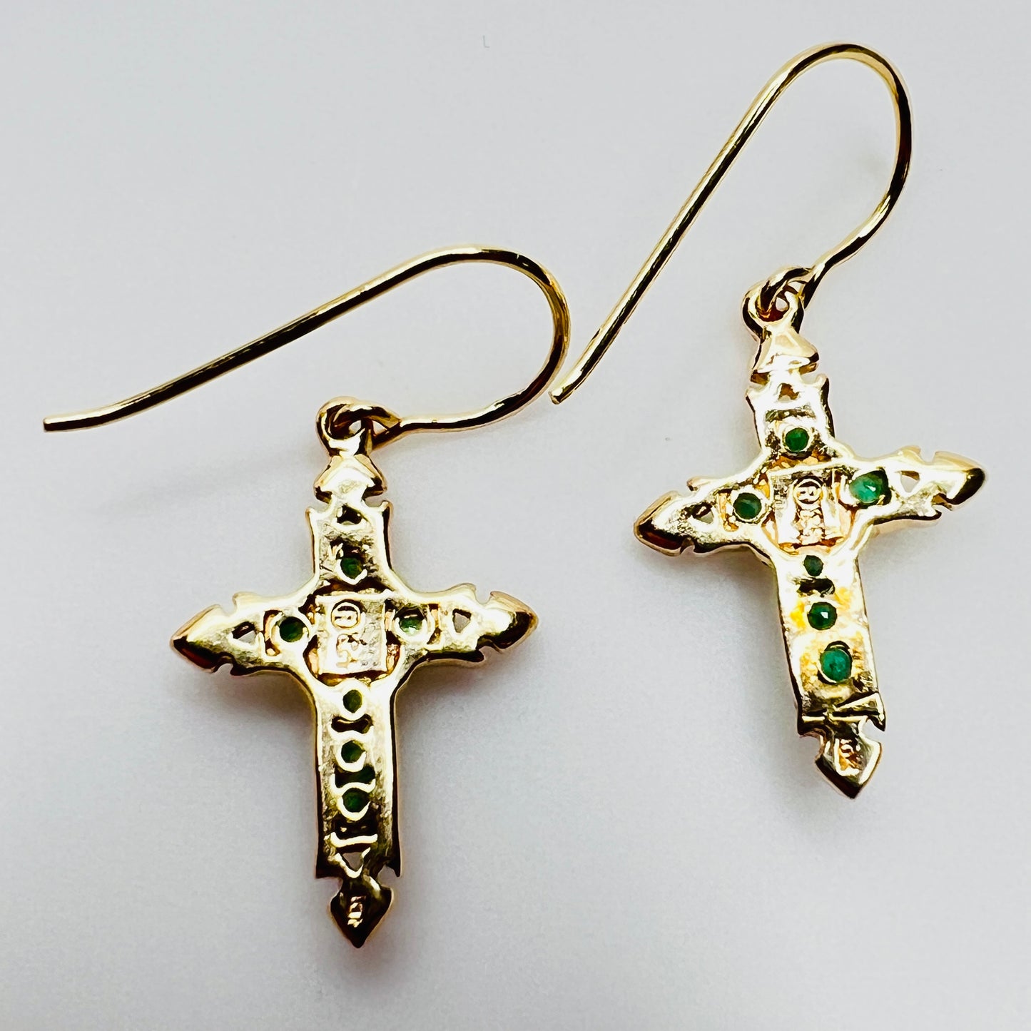 Back of gold cross earrings with gemstone settings