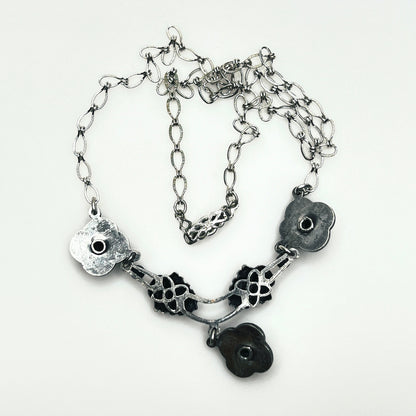 Reverse of vintage Art Nouveau Revival necklace showing openwork construction, chain and decorative hook clasp.