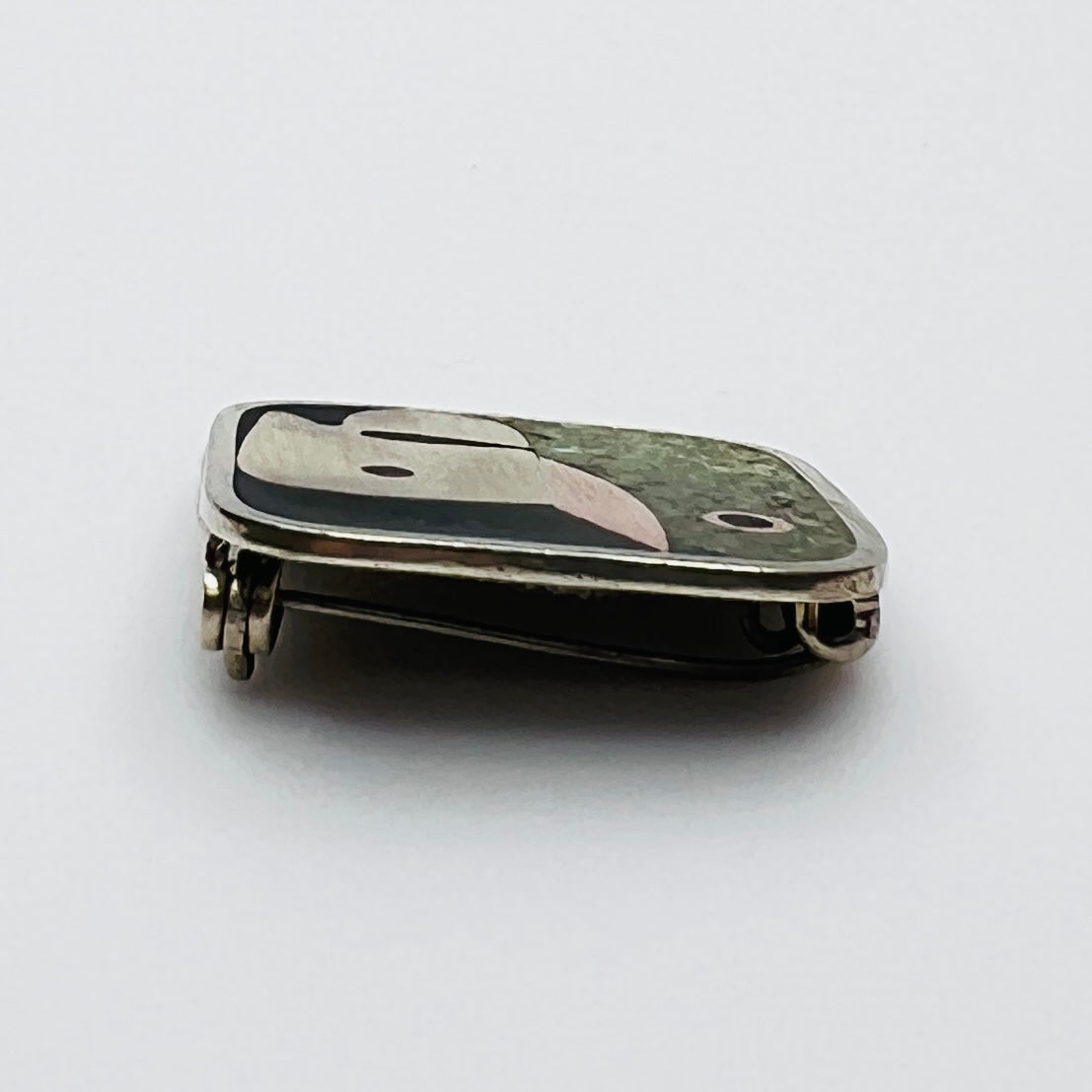 Side view of Taxco mixed metal artisan brooch